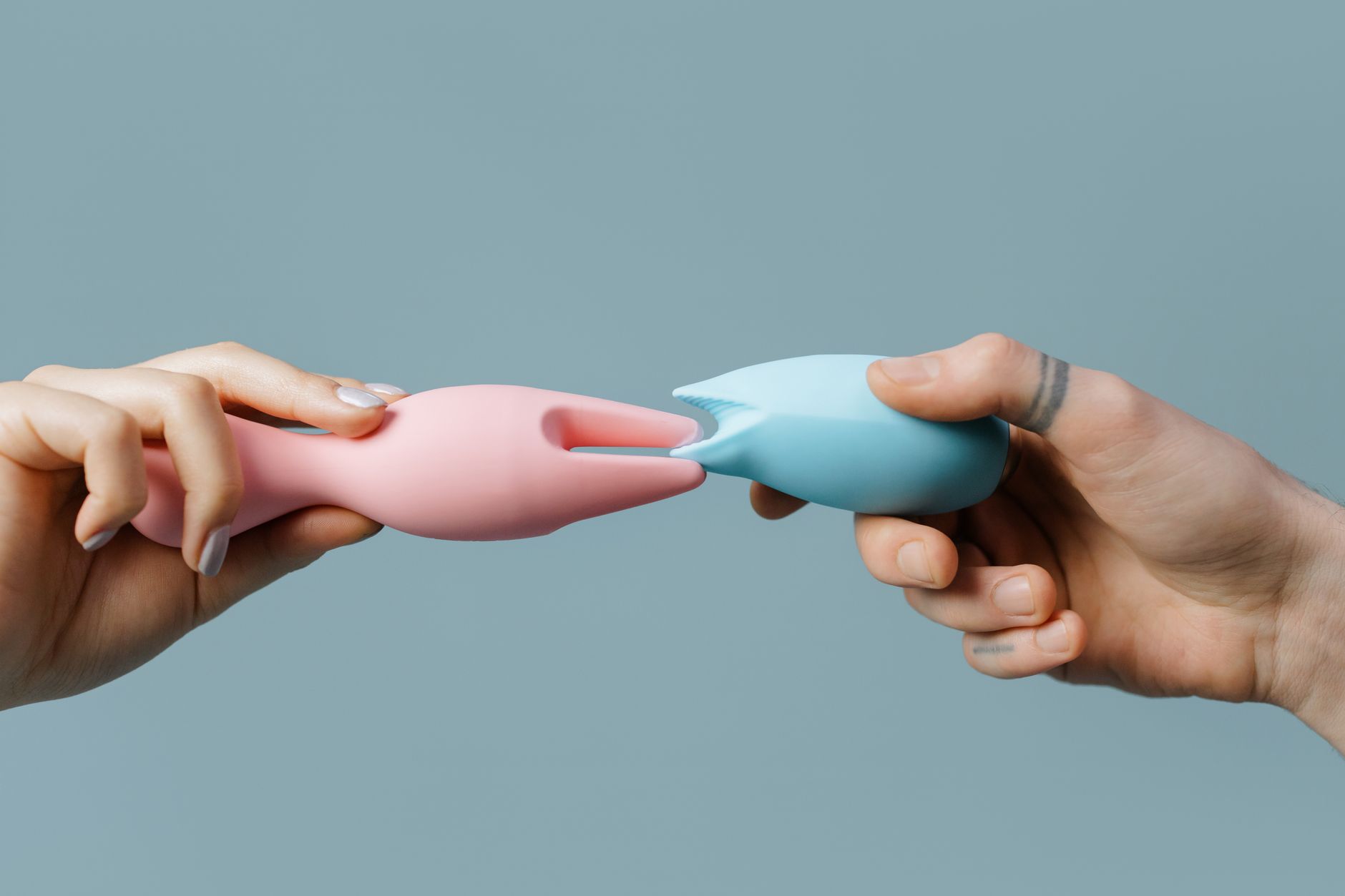 Person holding lemon clitoral vibrators thoughtfully, exploring sensation options
